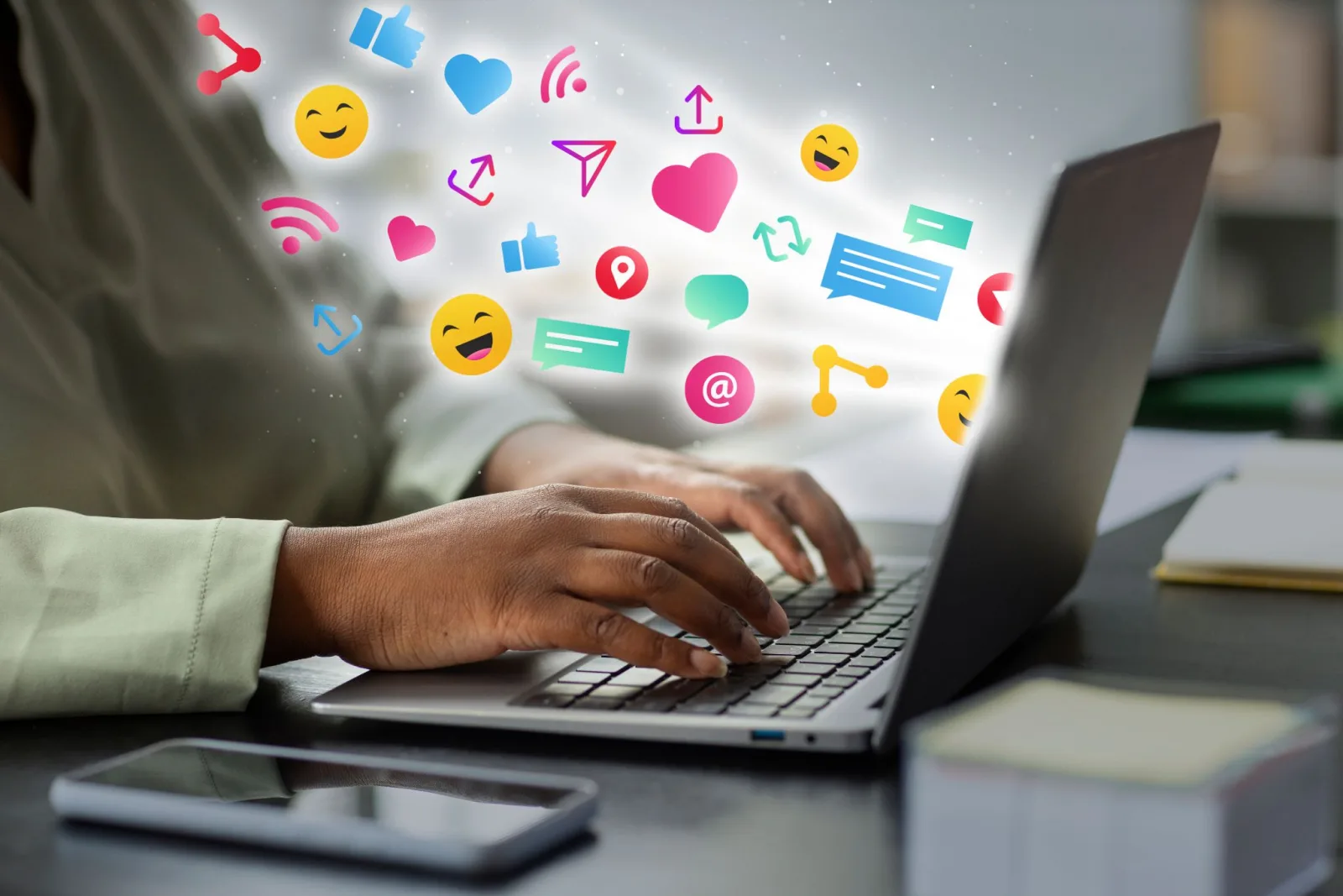 Social media reactions bursting from a laptop screen
